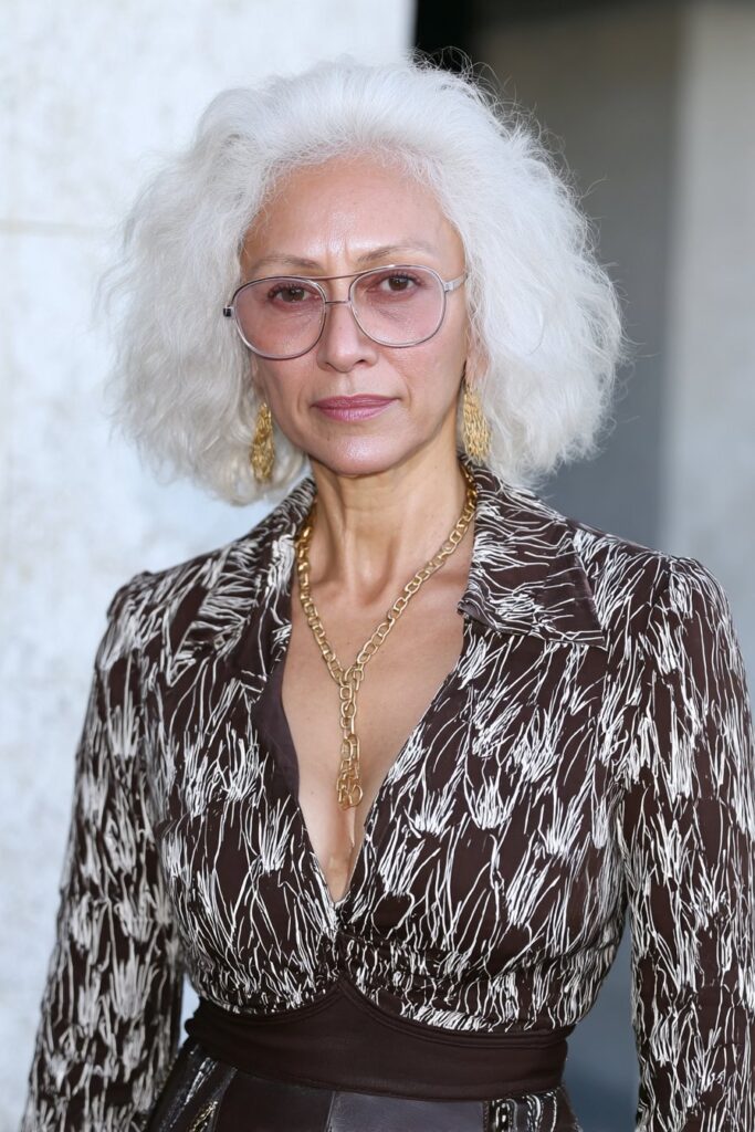 Ash mocha layered lob shag for woman over 50 with cool tones and volume.