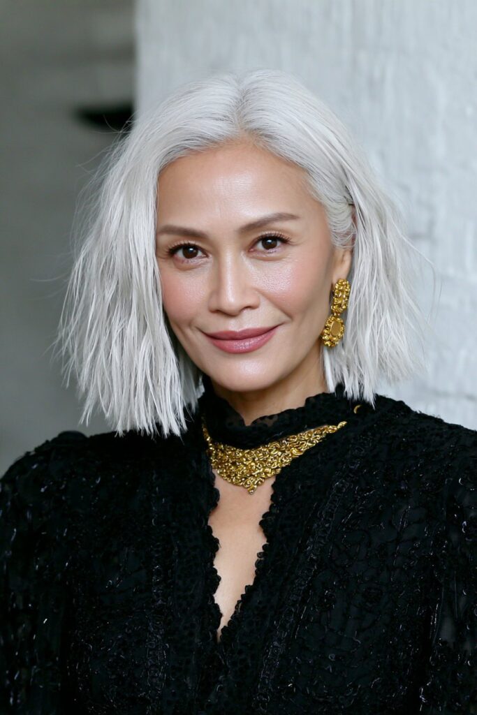 Chin-length shag hairstyle for woman over 50 with tousled ends and modern movement.