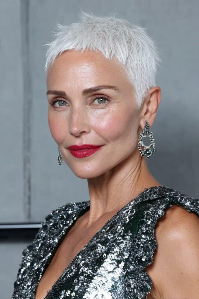 Choppy ash blonde pixie haircut with edgy layers and cool tone.