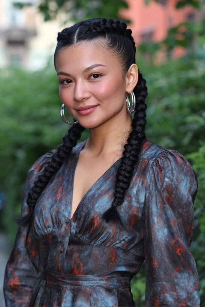 Classic box braids with curly ends adding volume and texture