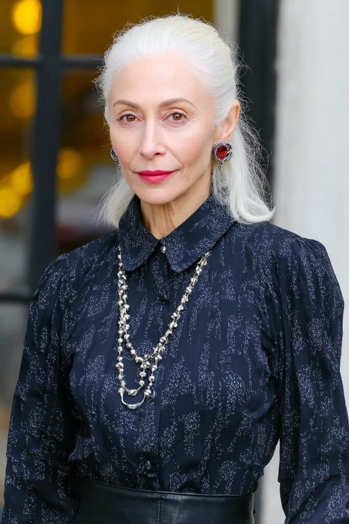 Vibrant copper red shag with side bangs for woman over 50 seeking a bold, youthful style.