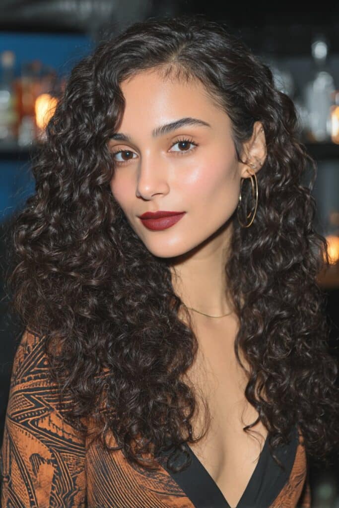 Crochet braided hairstyle with voluminous curly extensions