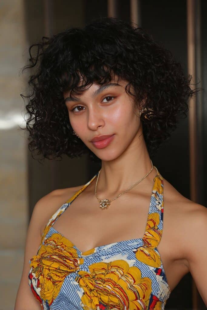 Girl with curly bob and front bangs.