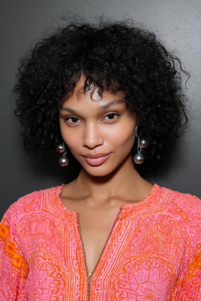 woman with curly boho bob and accessories