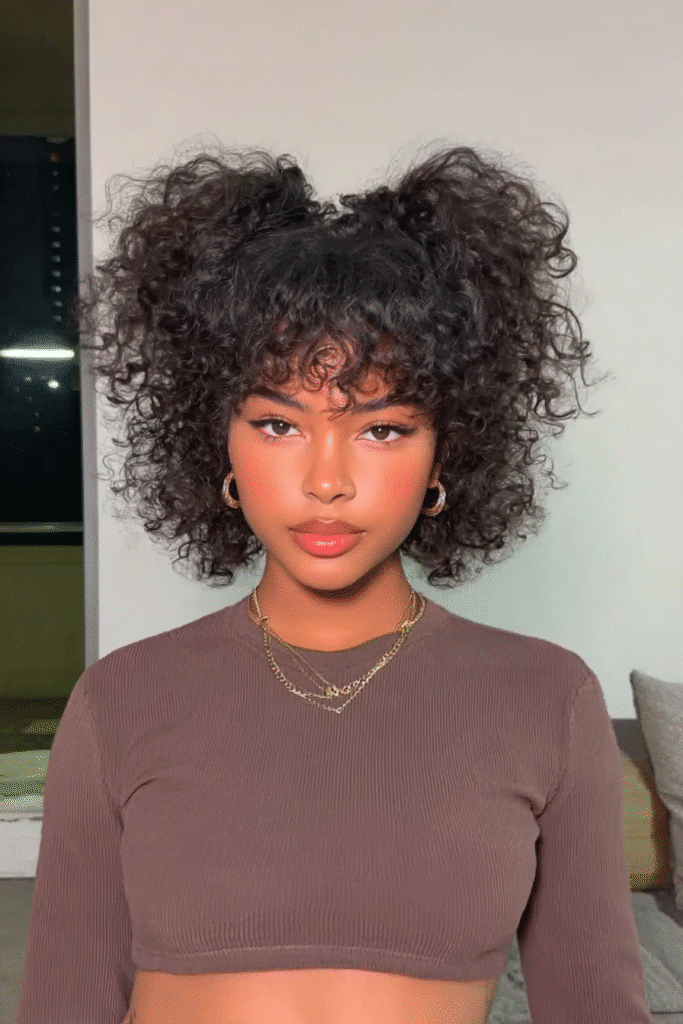 17 Stunning Half Up Half Down Quick Weave Hairstyles 16 A girl with a trendy half up half down quick weave featuring a top knot bun.