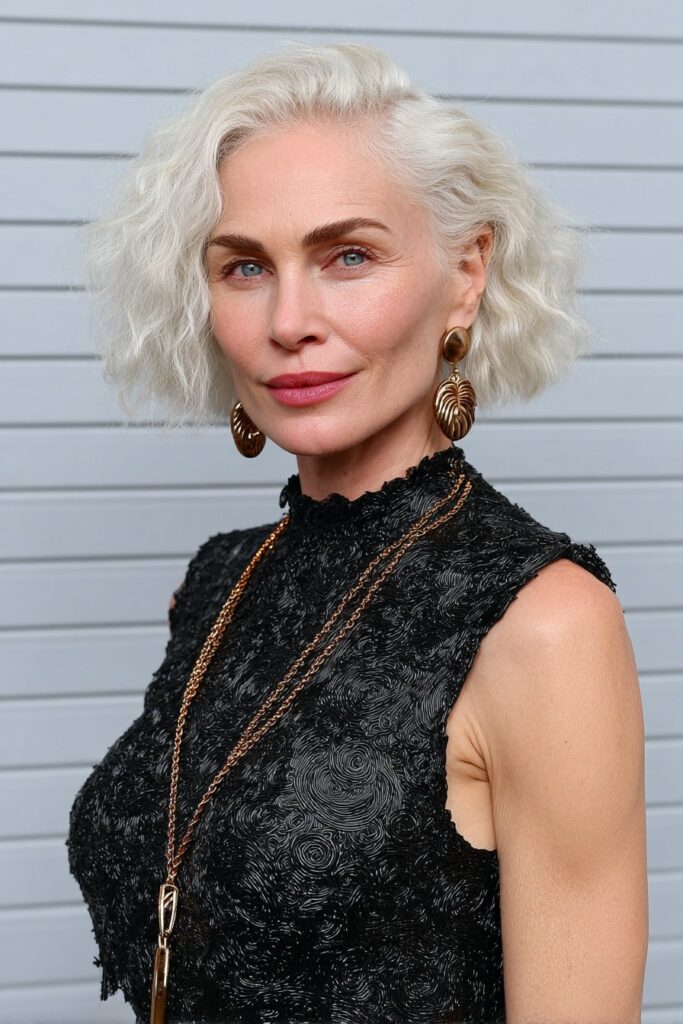 Curved top pixie haircut styled with defined texture for volume and edge.