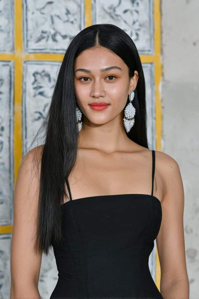 Girl with defined centre-part lob.