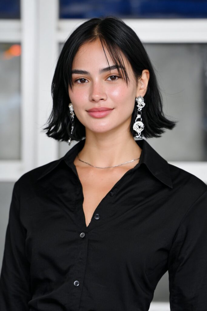 Woman with a bouncy bob hairstyle that frames the face.