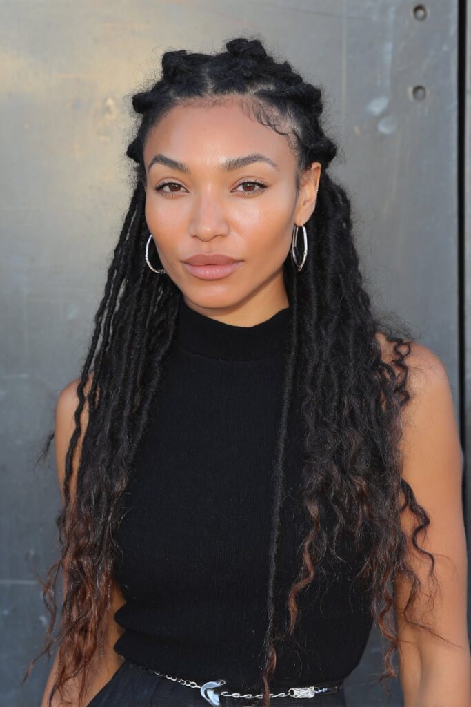 French Curl Braids with Heart Parting on a woman with cute heart-shaped part design