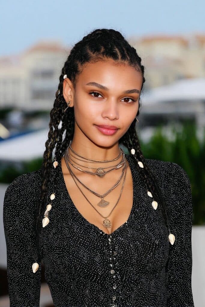 French Curl Braids with Shell Accessories on a woman with shells added to her curls