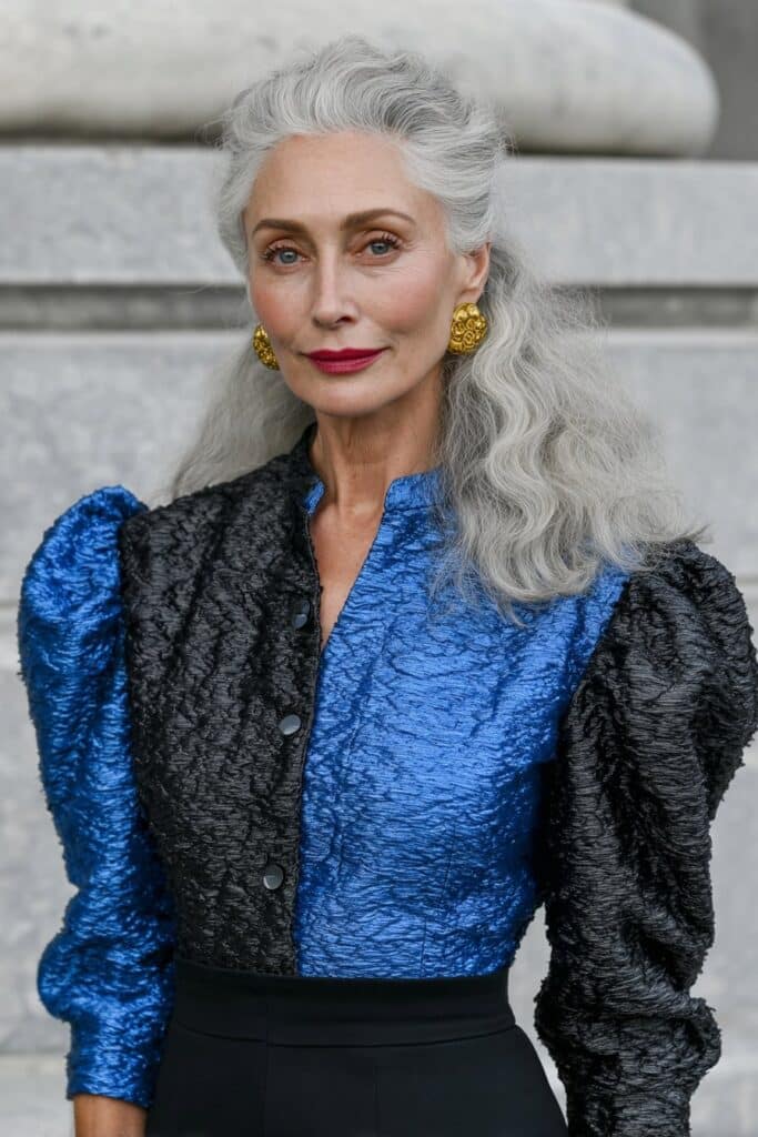 Golden blonde wavy shag for woman over 50 with sun-kissed layers and soft waves.