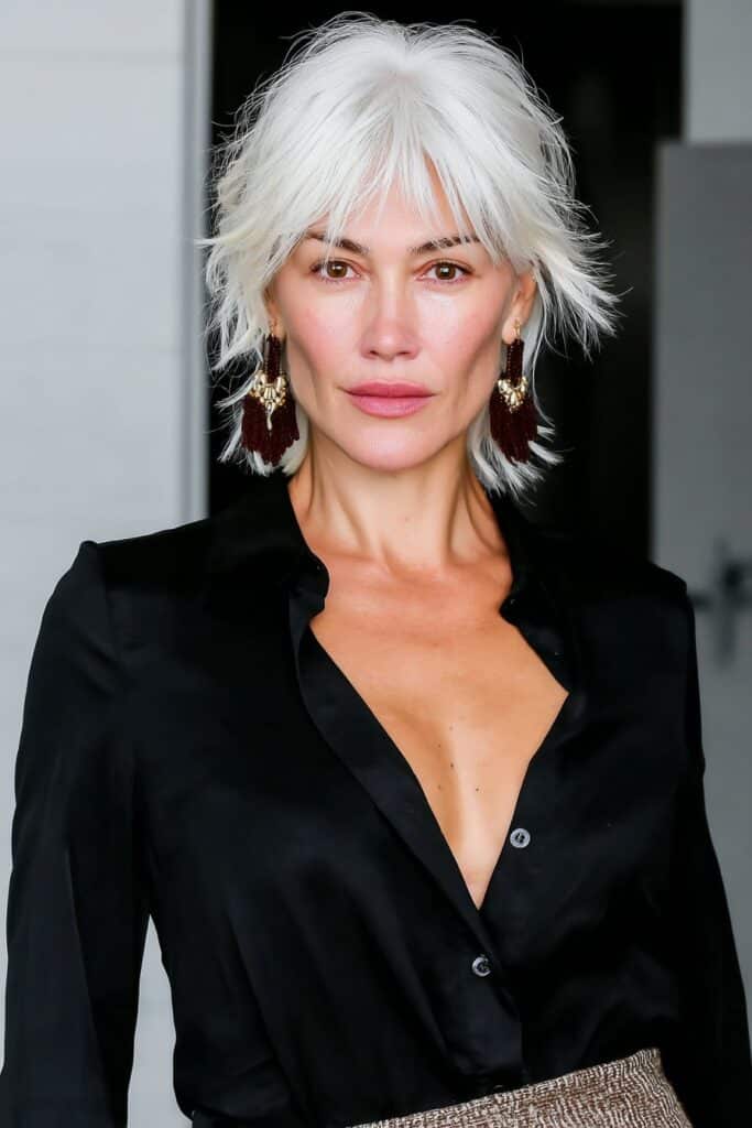 Golden caramel shag with curtain layers for woman over 50 with warm, dimensional tones.