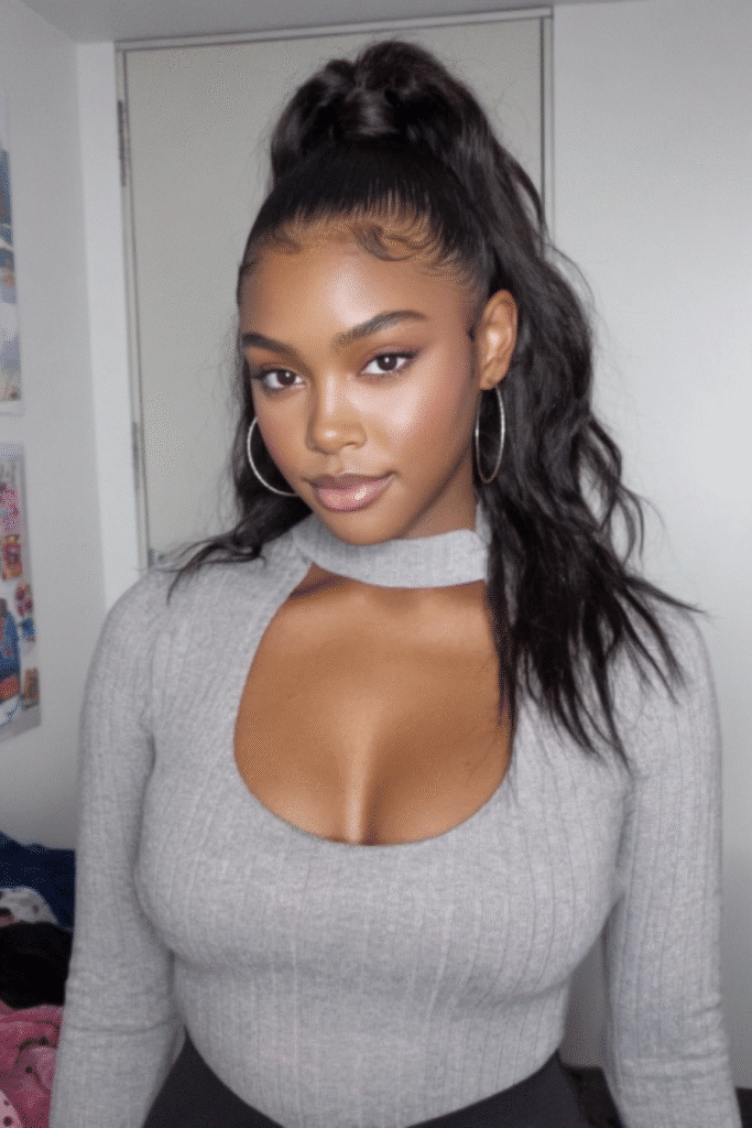 17 Stunning Half Up Half Down Quick Weave Hairstyles 7 A woman with a natural half up half down quick weave featuring a smooth leave out blend.