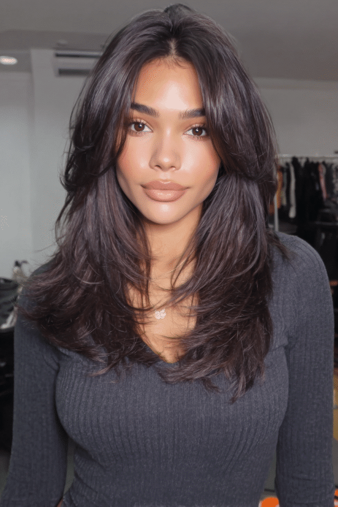 17 Stunning Half Up Half Down Quick Weave Hairstyles 13 A woman wearing a half up half down quick weave with a clean middle part.