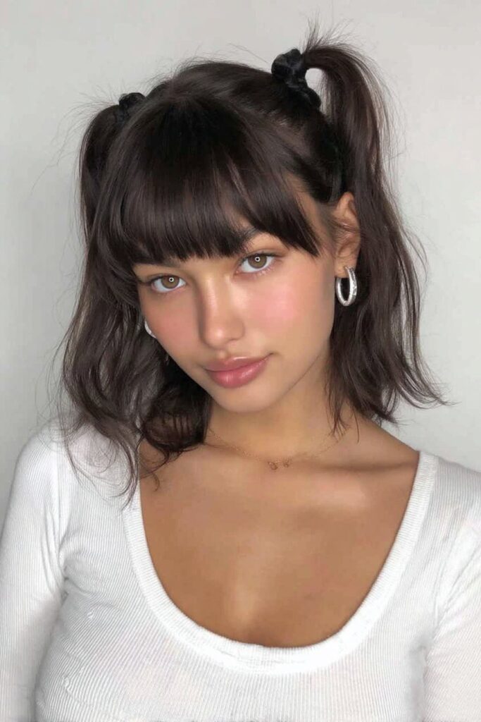 17 Stunning Half Up Half Down Pigtails to Try Today 9 A person with half up half down pigtails and bangs hairstyle