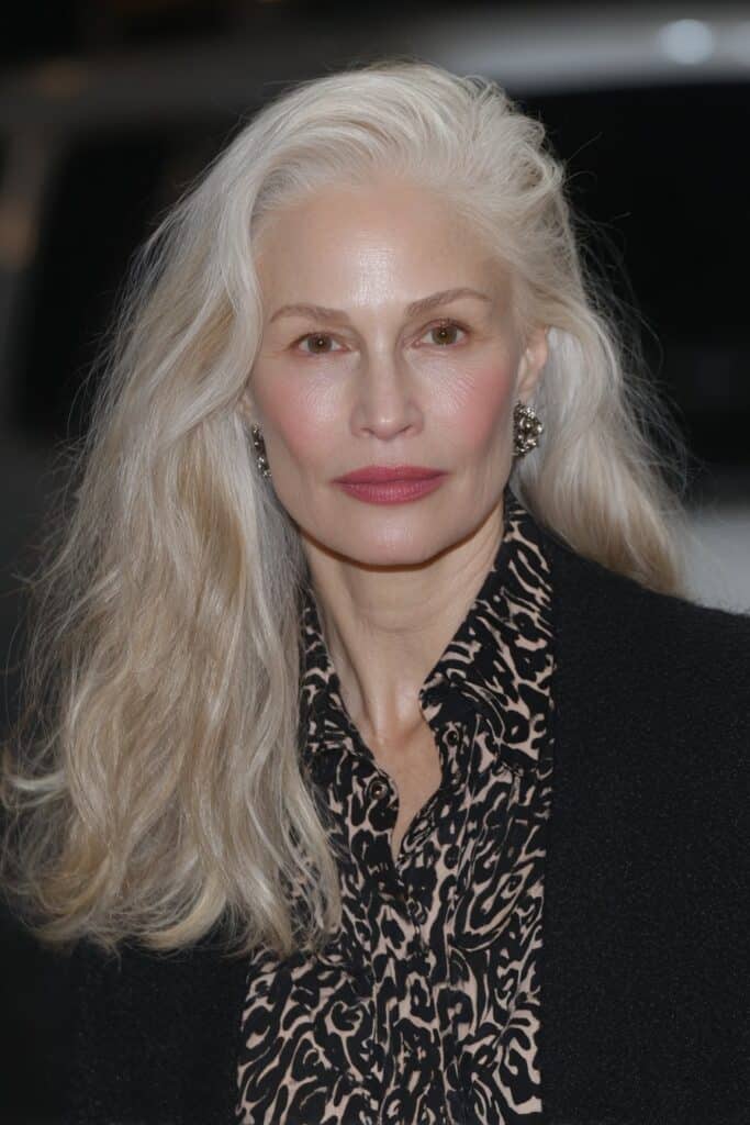 Honey blonde long shag haircut for woman over 50 with soft face-framing layers.