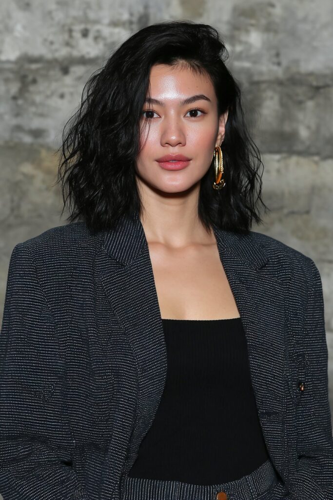 Stylish woman with a layered bob haircut and airy texture.