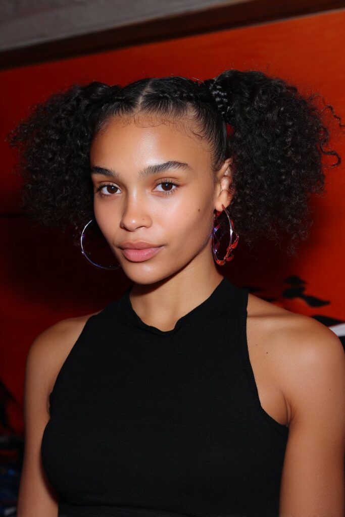 Layered French Curl Knotless Braids on a girl with layered braid lengths and curls