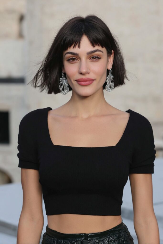 Girl with long bob and thick side bangs.