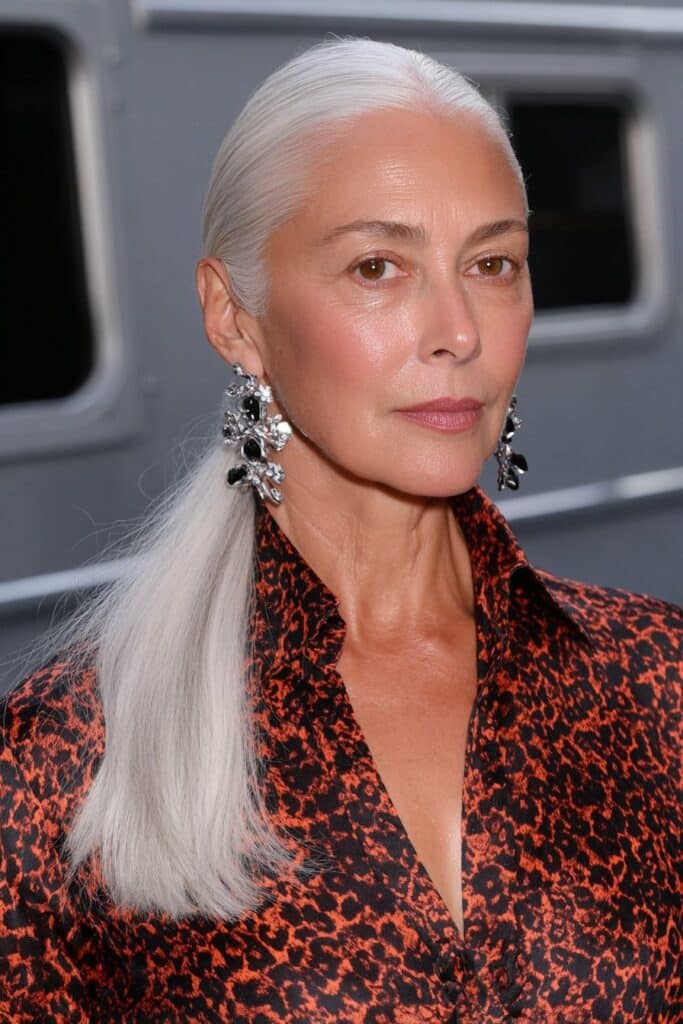 Medium shag haircut with curtain bangs for woman over 50 adding soft volume and shape.