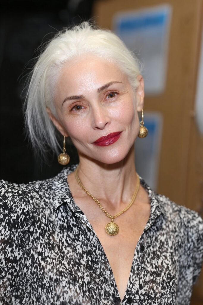 Salt and pepper textured shag hairstyle for woman over 50 embracing natural gray hair.