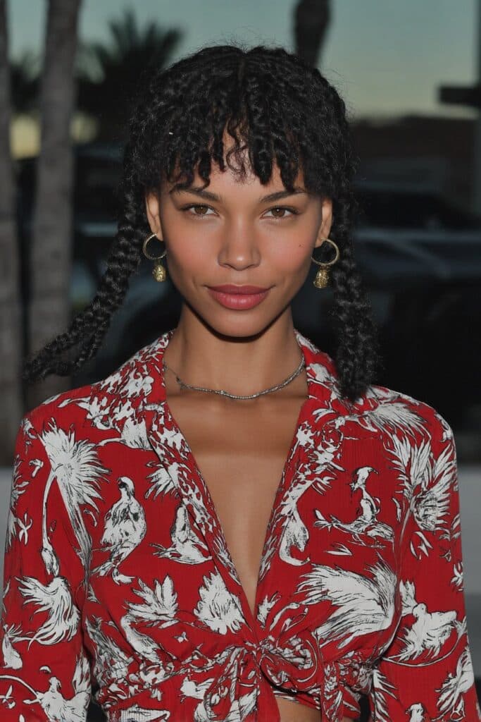 woman with short box braids with curly ends