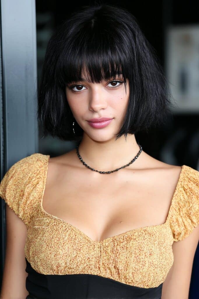 Girl with shoulder-length bob and curtain bangs.