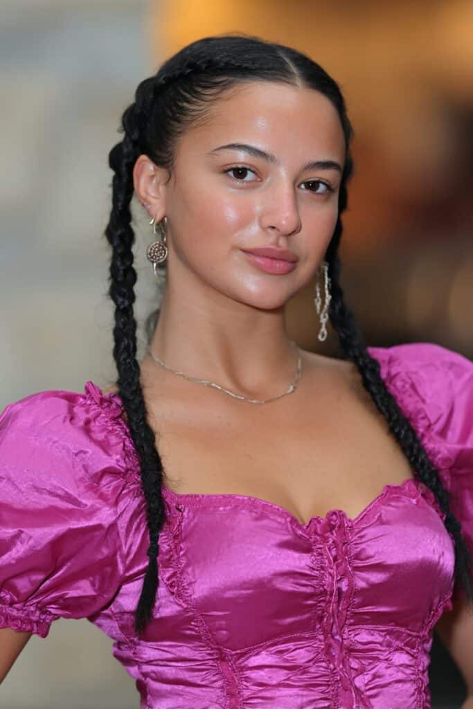 Side cornrows styled with loose flowing hair for a trendy winter style