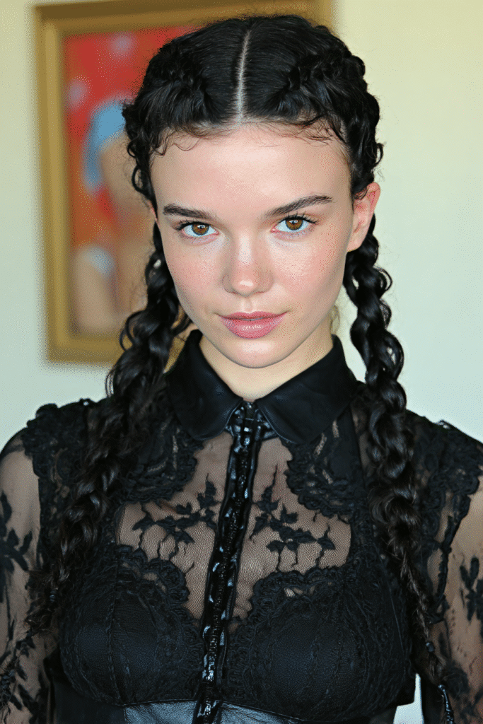 Girl with side-part knotless braids and loose curls