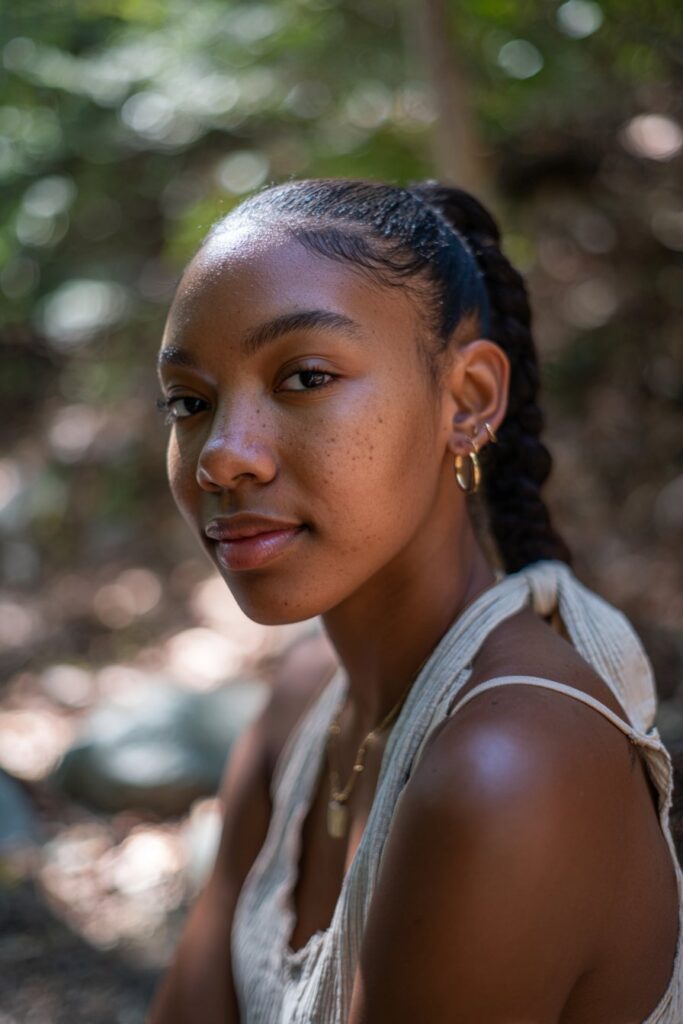 Young black woman with slick back drawstring ponytail hairstyle