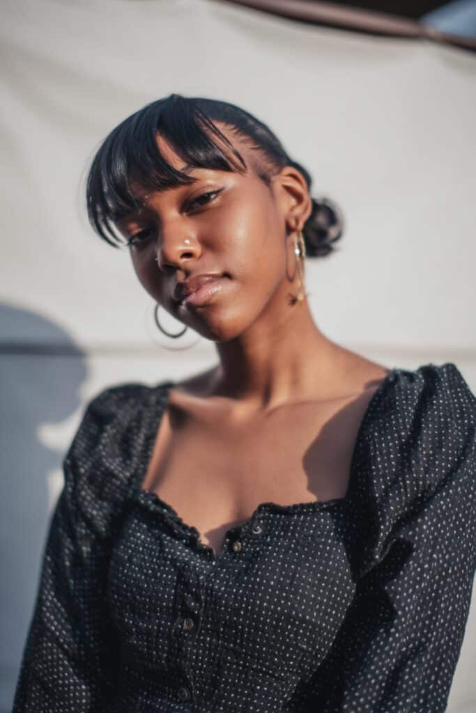 Young black woman with slick back swoop bang hairstyle