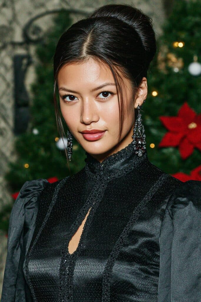 Trendy textured half-up bun for a girl with medium hair, creating a relaxed and effortless look.