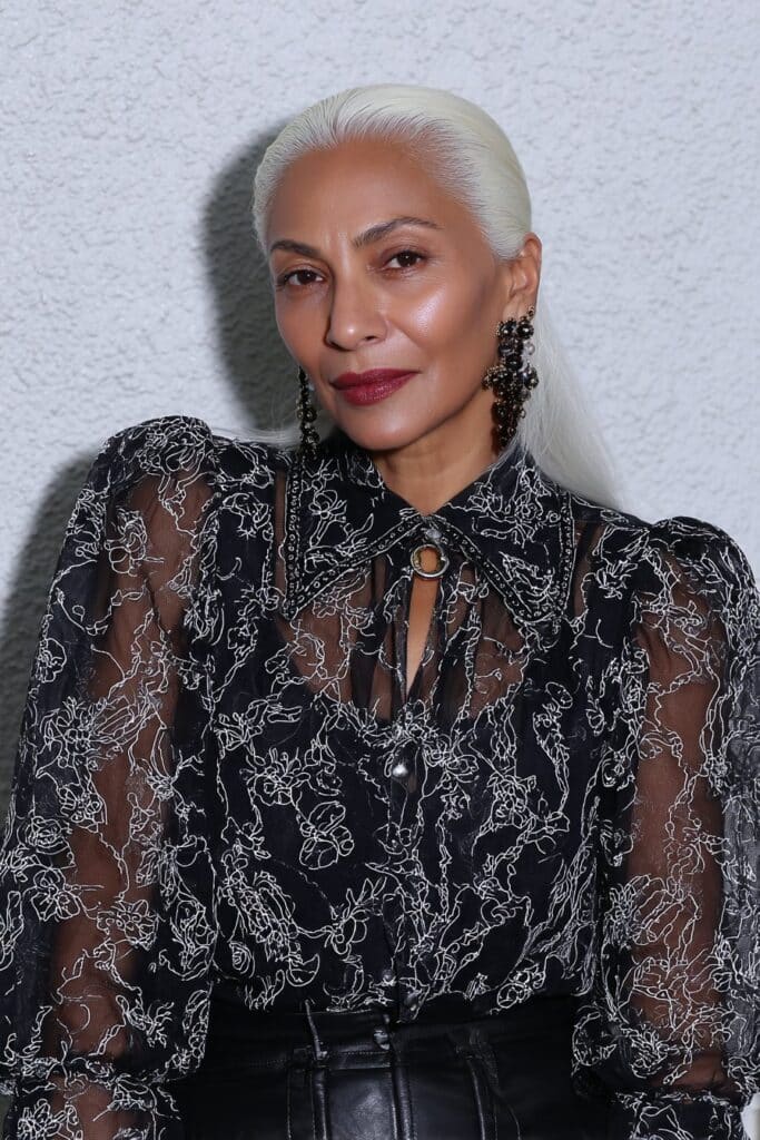 Tousled caramel pixie cut with long bangs creating warm, relaxed texture.