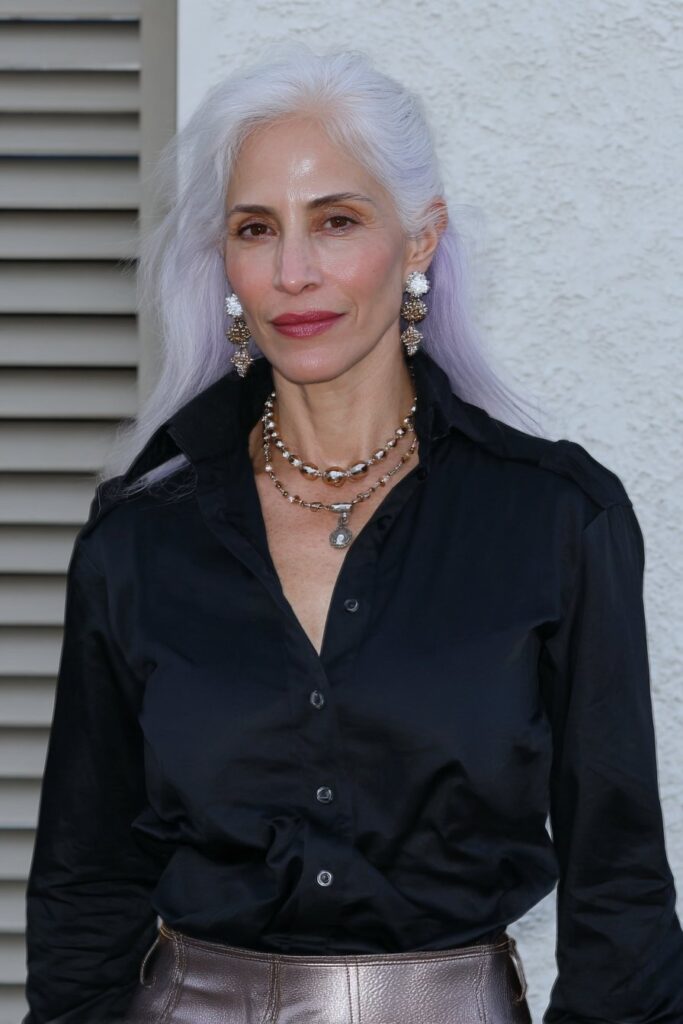 Soft wavy pixie haircut with face-framing layers enhancing natural curls.