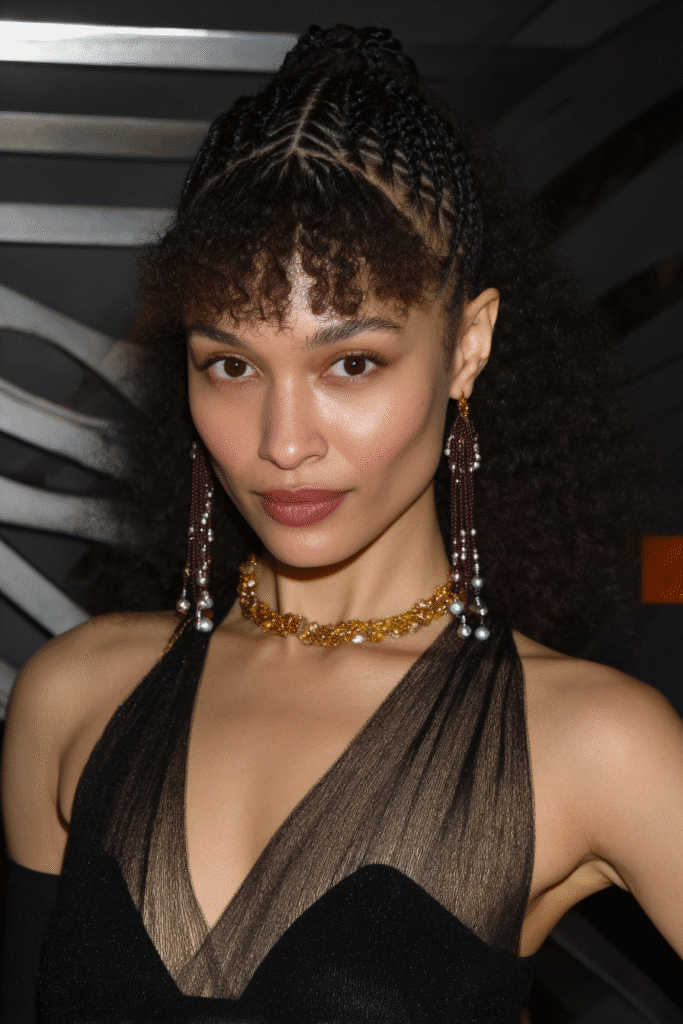 Woman with knotless braids decorated with beads and curls