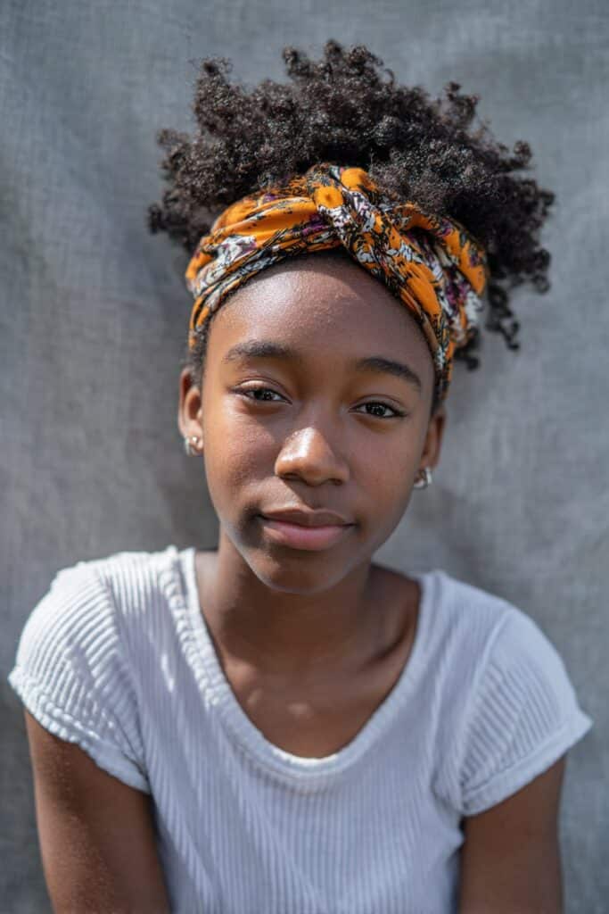 A rounded afro accented with a bold, statement headband.