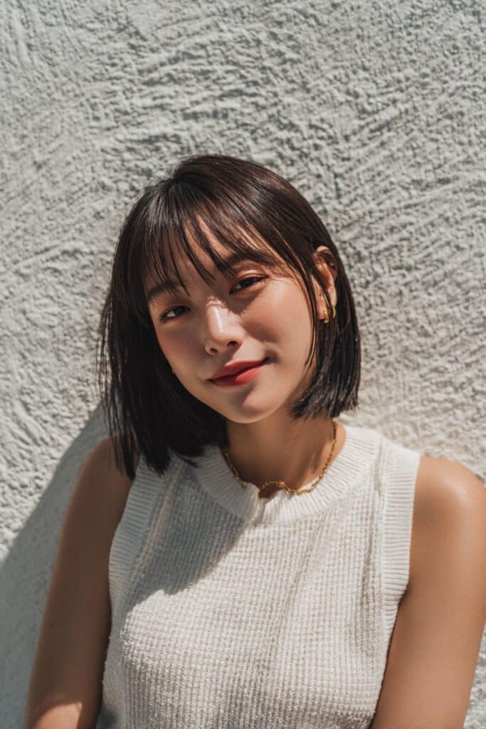 Tousled butterfly layers with beachy texture and airy curtain bangs.