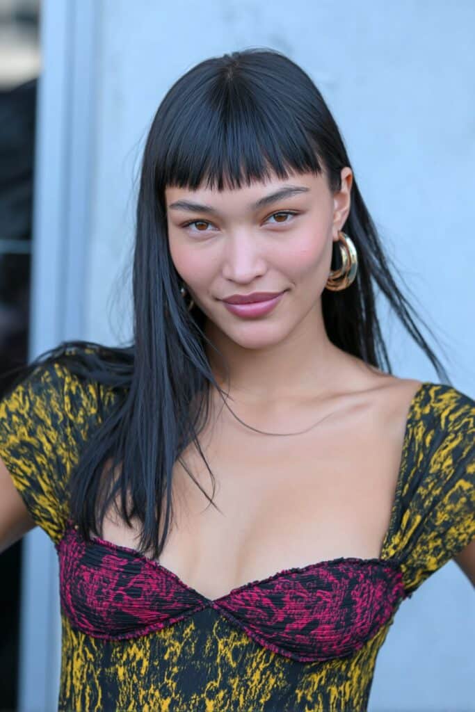 Woman with blunt lob haircut and long front bangs