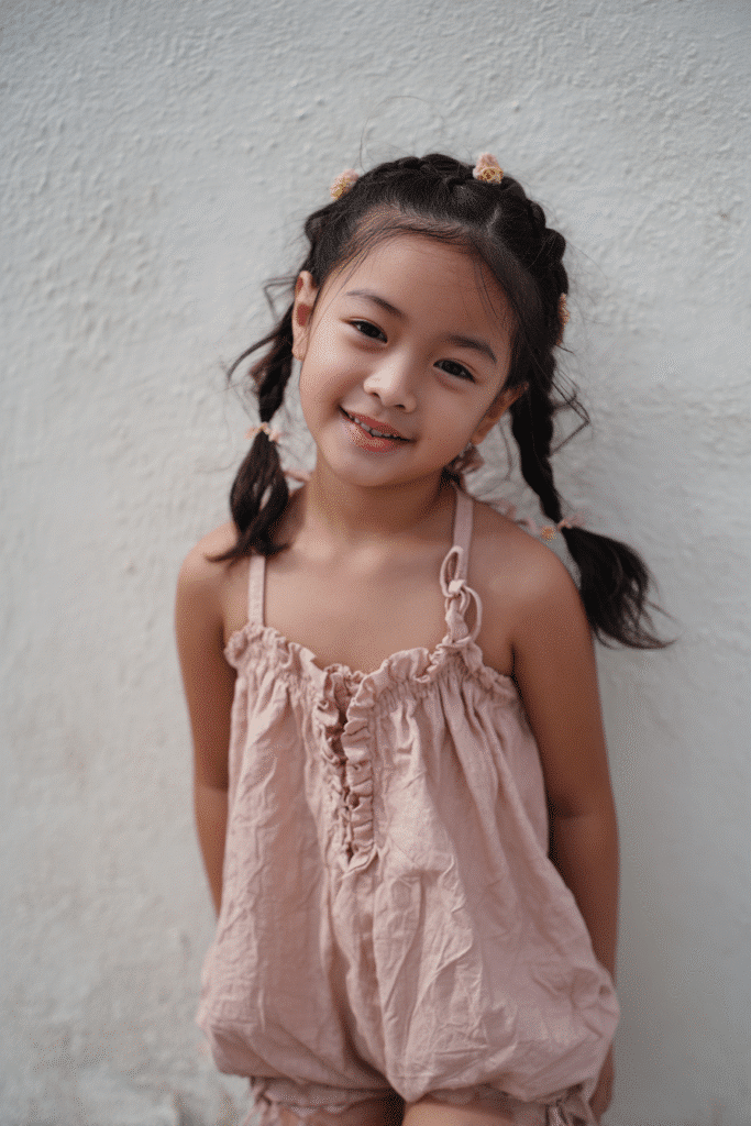 Braided hair worn like a headband across the front, creating a relaxed, bohemian style.