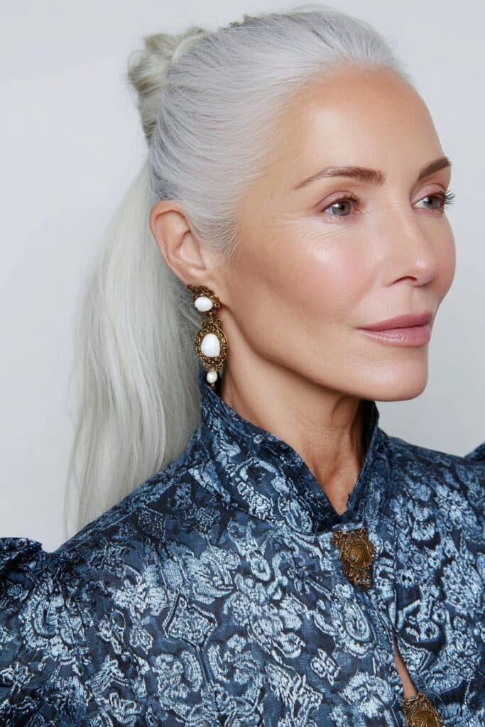 60-year-old woman with auburn-toned butterfly layers giving a warm, radiant glow to mature skin.