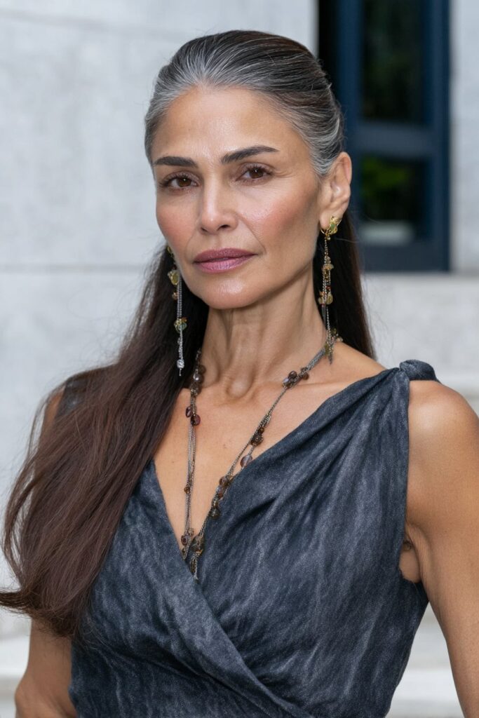 Confident 60-year-old woman with a butterfly cut featuring deep layers for full-bodied volume.