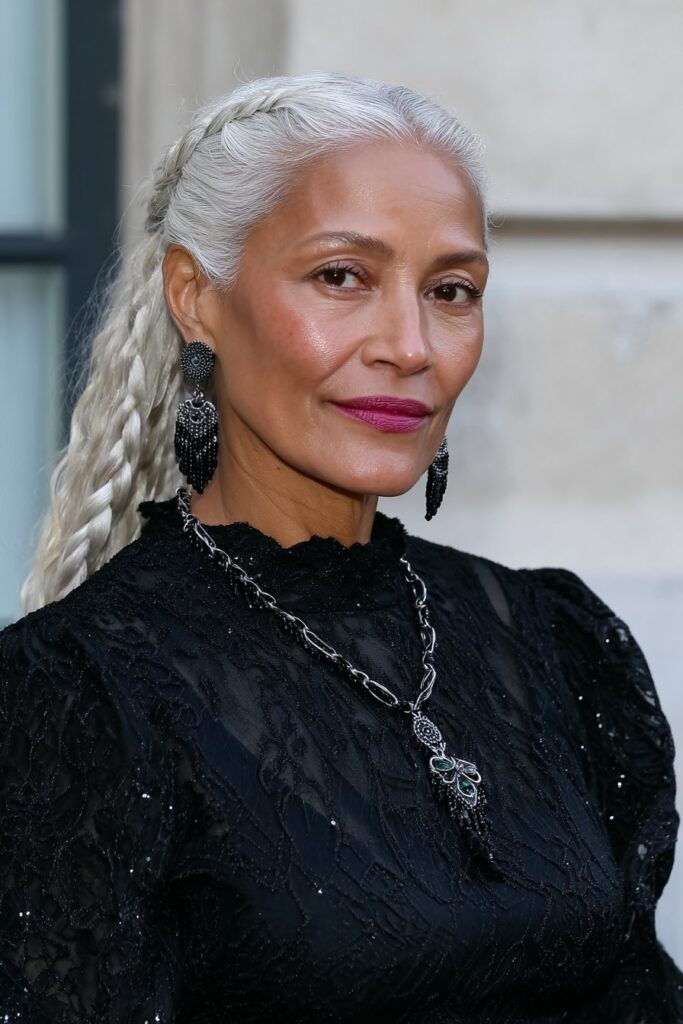 Chic 60-year-old woman wearing a butterfly cut with a side part for a flattering, lifted look.