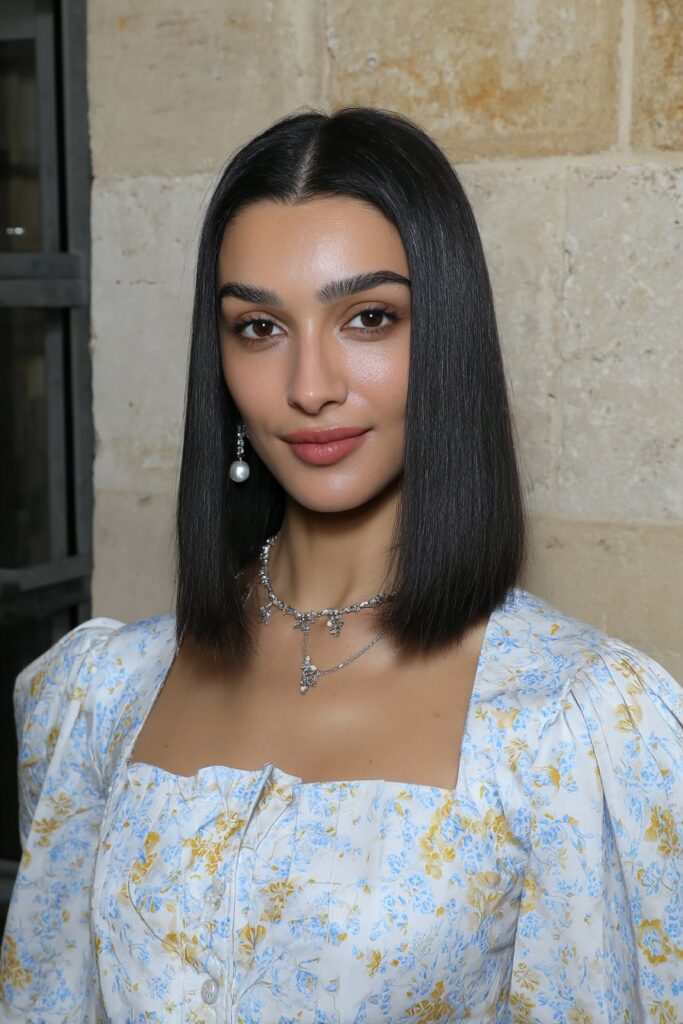 A girl with highlighted butterfly layers in medium hair