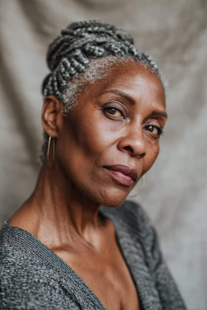 Cornrows wrapped around the head in a circular crown pattern for a regal, halo-like style.