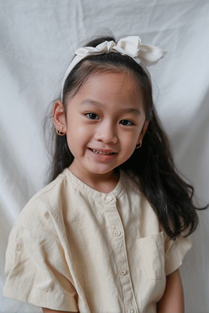 Smooth hair or natural texture paired with a sleek satin headband for a timeless, refined look.