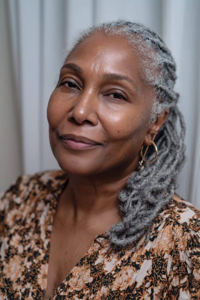 Neat cornrows braided diagonally across the scalp and swept to one side for a soft, elegant finish.