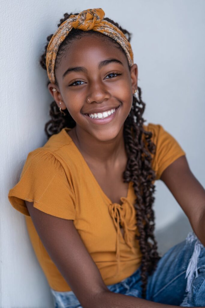 Locs styled to fall naturally toward the back for a simple, relaxed look.