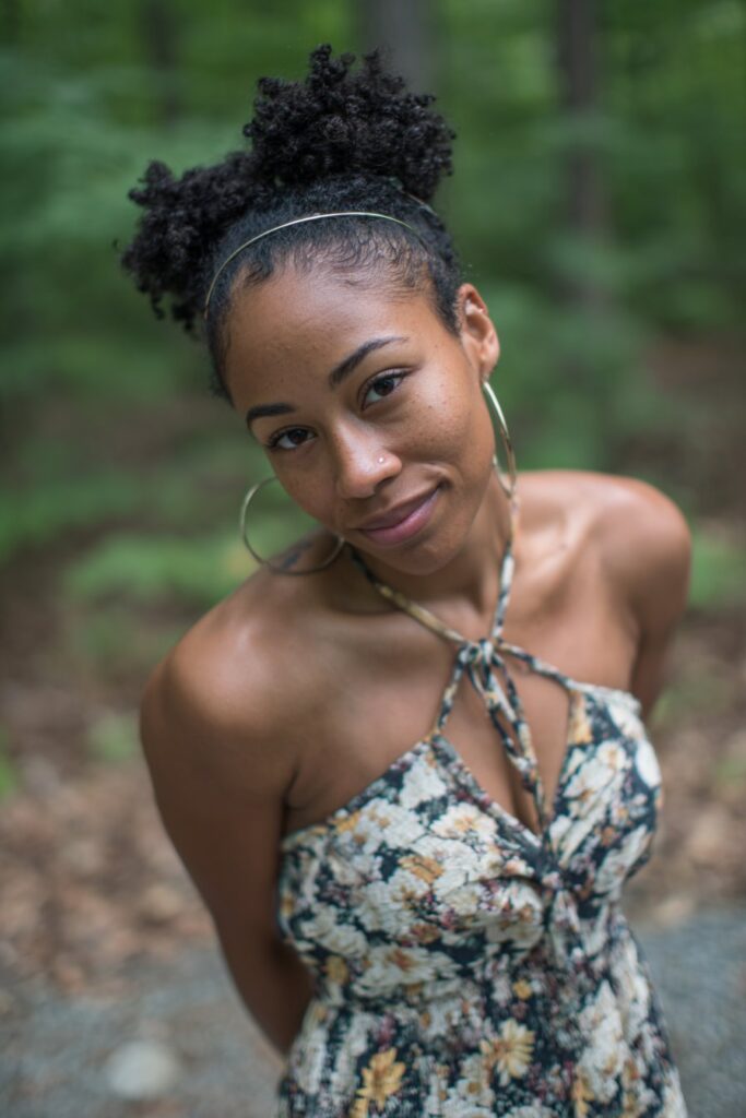 Hair styled half-up with a smooth, swooped front section framing the face.