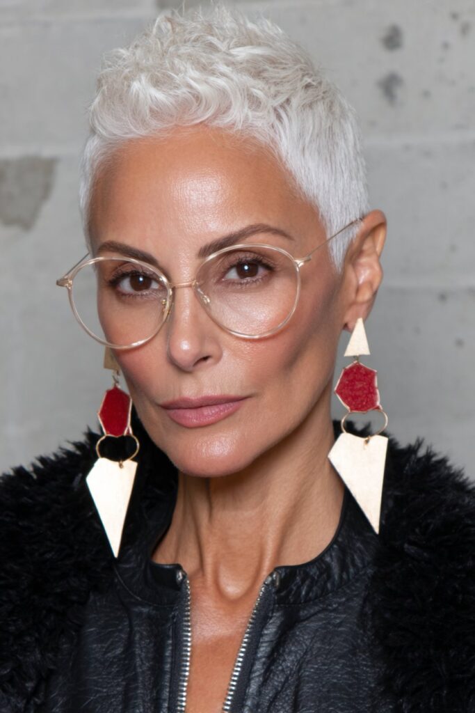 Elegant woman over 60 with a longer pixie cut styled with extra crown volume for a lifted appearance.