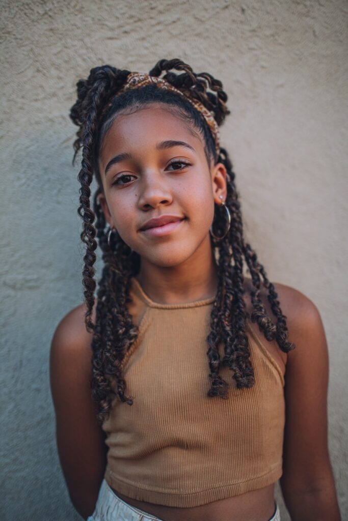 Soft crown braids wrapped around the head with a twisted bang in front.